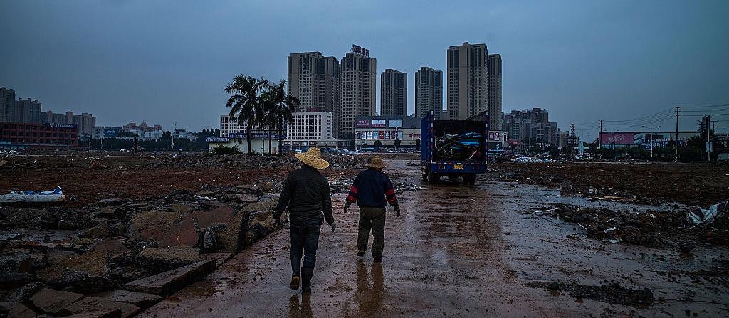 Workers walk on a path at a demolished industrial area in Dongguan, China. (© Lam Yik Fei, Getty Images)